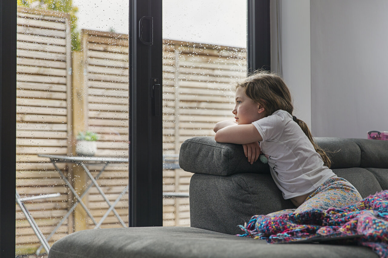 Sad girl looking out the window