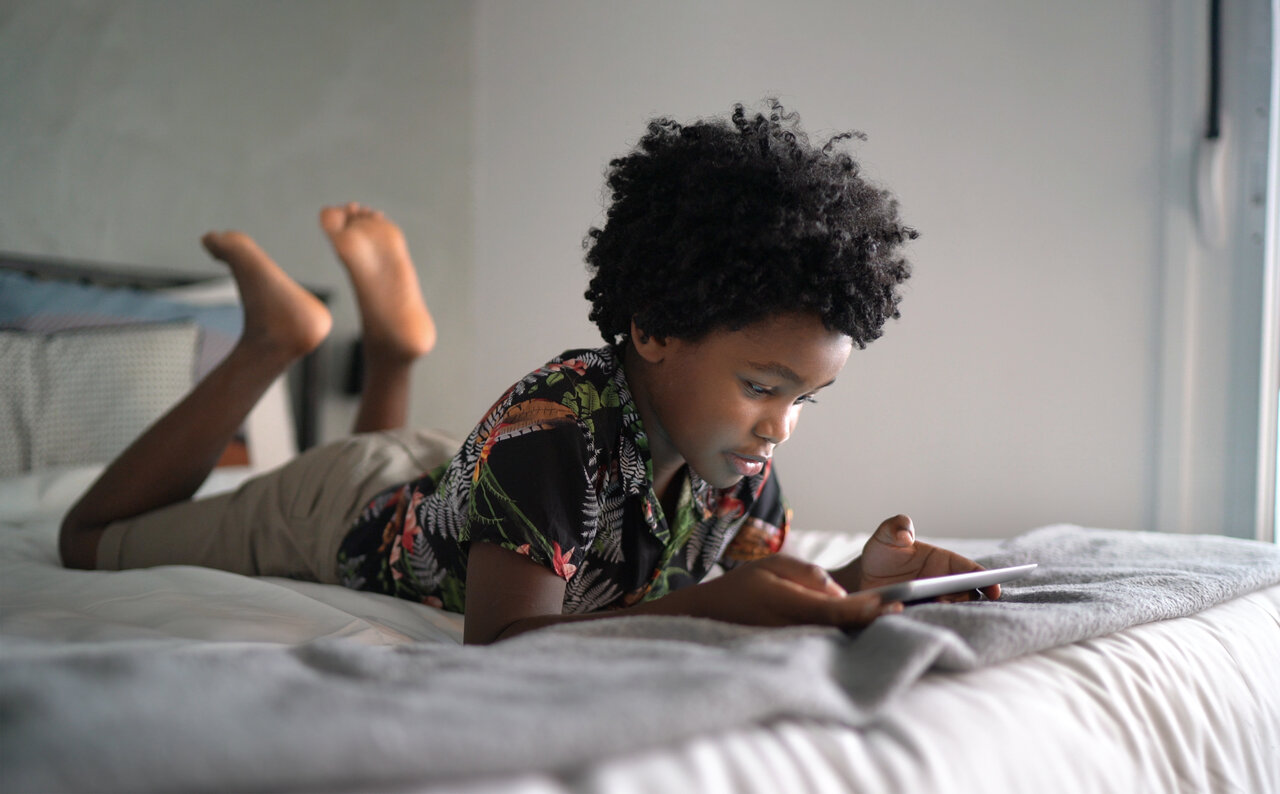 Boy playing game on tablet