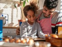 father and daughter cooking together