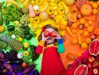 girl with different colour fruits and vegetables