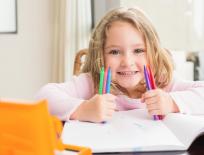 girl with pens, a notebook and pencil case