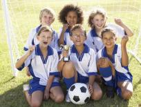 smiling children on a football pitch