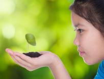 girl looking at a plant