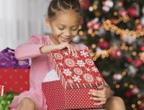 girl opening a Christmas present