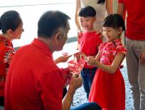 children receiving red envelopes from grandparents