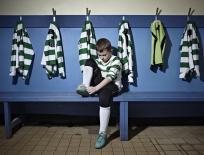 boy putting on football boots