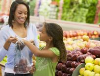 mother and daughter buying fruit