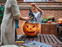 family carving a pumpkin