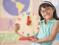 girl holding a clock