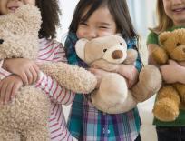 Children hugging teddy bears