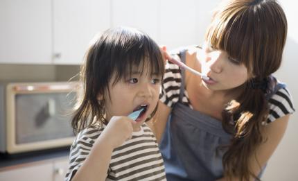 mother and child brushing their teeth