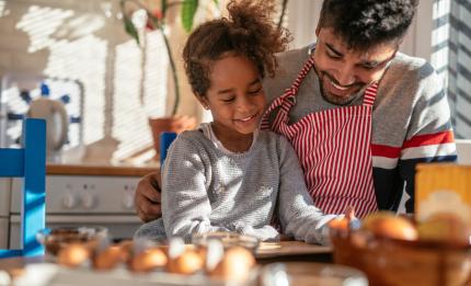 father and daughter cooking together