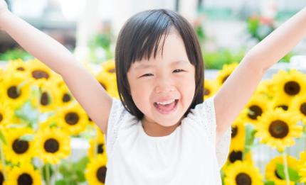 smiling girl in front of sunflowers