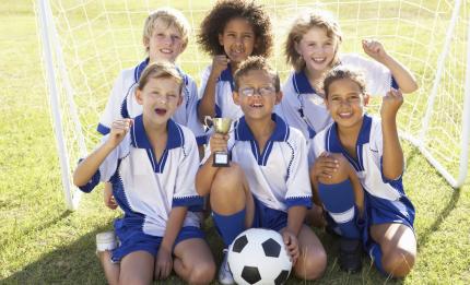 smiling children on a football pitch