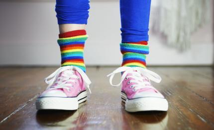 child wearing colourful socks and shoes