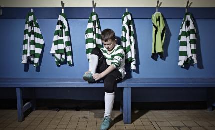 boy putting on football boots