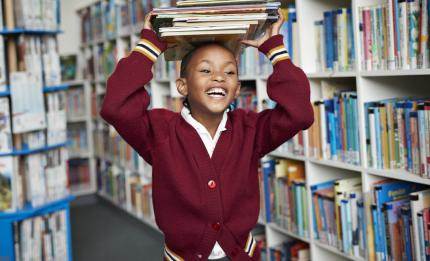 child with books on their head