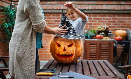 family carving a pumpkin