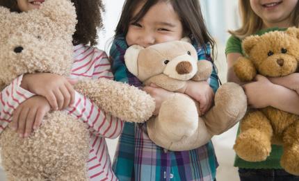 Children hugging teddy bears