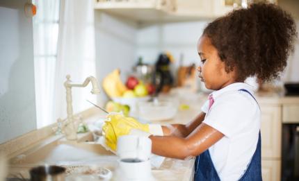 girl washing up in the kitchen