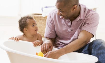 father and toddler at bathtime