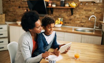 woman and child looking at tablet at home