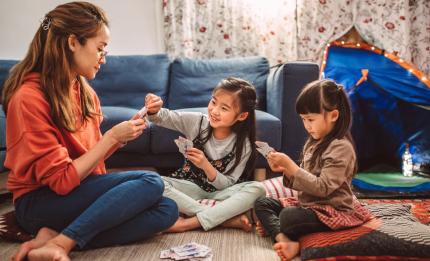 woman and children playing cards