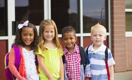 children standing outside a school