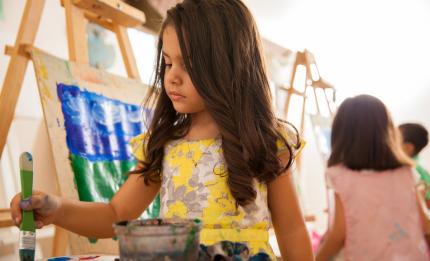 girl painting in art class