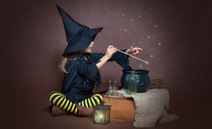 girl dressed as a witch making a spell