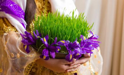 girl holding wheat grass and irises