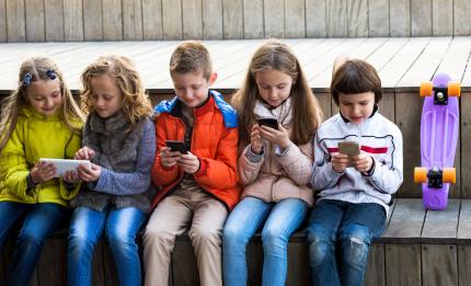 children using their phones and tablet