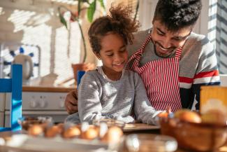 father and daughter cooking together