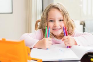 girl with pens, a notebook and pencil case