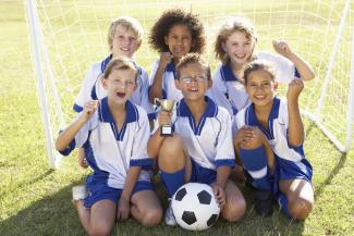 smiling children on a football pitch