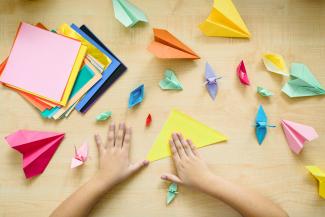 hands making origami