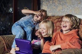 brother and sisters laughing