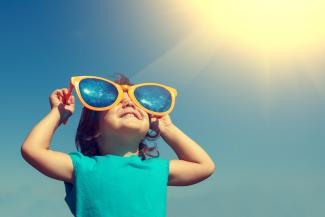 child wearing big sunglasses