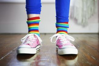 child wearing colourful socks and shoes