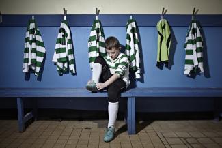 boy putting on football boots