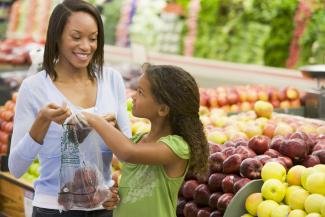 mother and daughter buying fruit