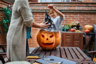 family carving a pumpkin