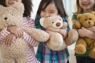 Children hugging teddy bears