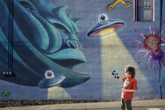 painting on a wall with monster and aliens