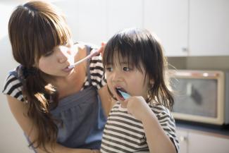 mother and child brushing their teeth