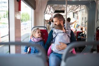 father and children on the bus