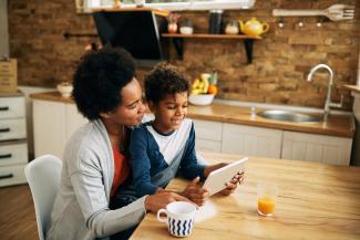 woman and child looking at tablet at home