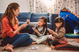 woman and children playing cards