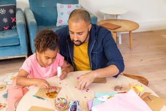 father and daughter doing crafts