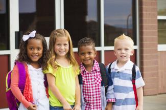 children standing outside a school